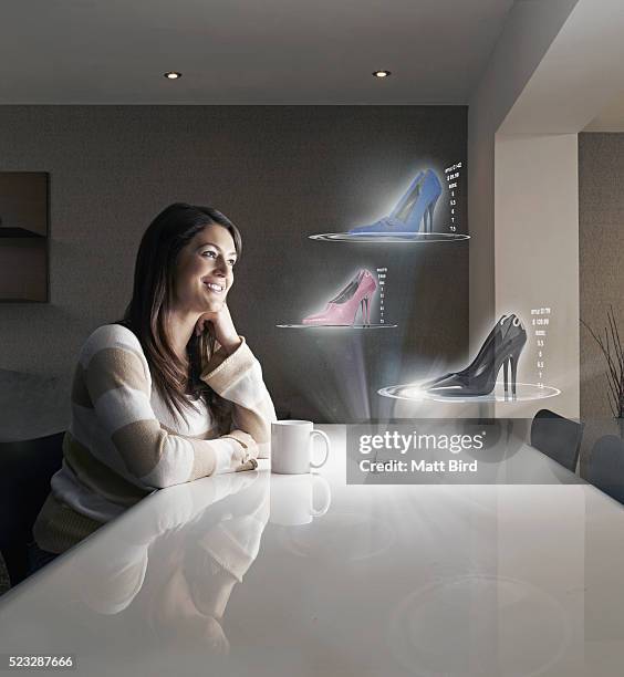 woman shopping online on futuristic 3d device - choosing shoes stock pictures, royalty-free photos & images