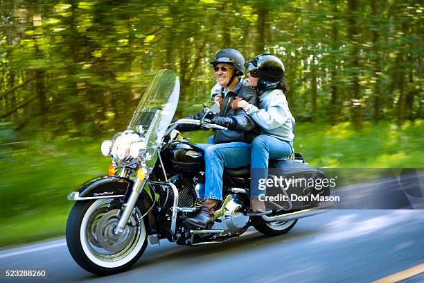 couple motorcycling along rural road - motorcycle stock pictures, royalty-free photos & images