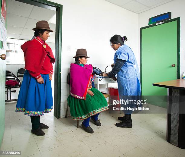 nurse taking patient's blood pressure, ecuador - ecuador people stock pictures, royalty-free photos & images