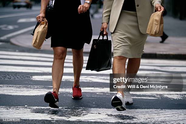 businesswomen walking in athletic shoes - working footwear stock pictures, royalty-free photos & images