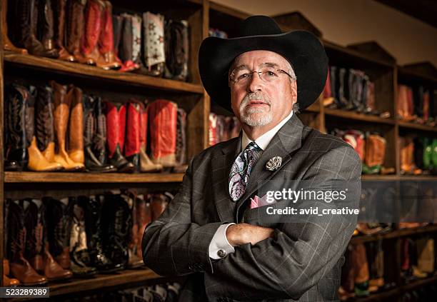 cowboy boot store owner portrait - west texas stock pictures, royalty-free photos & images