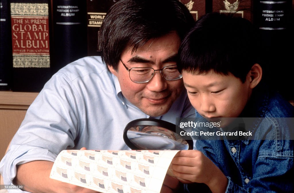 Father and Son Examining Stamps