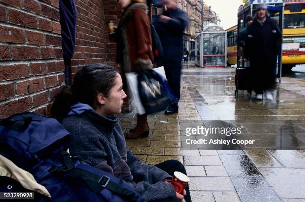 young homeless woman begging on sidewalk in leeds - homeless person stockfoto's en -beelden
