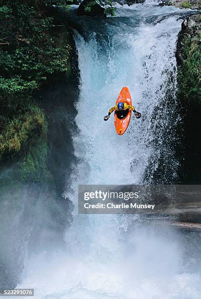 kayaker maneuvering over spirit falls - white water kayaking stock pictures, royalty-free photos & images