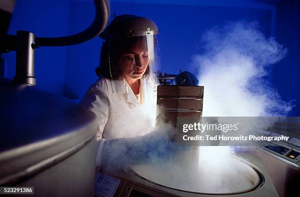 lab technician holding frozen virus samples - biotechnology lab stock-fotos und bilder