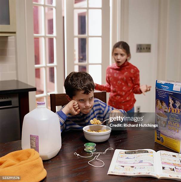 sister shouting at brother during breakfast - cereal boxes stock pictures, royalty-free photos & images