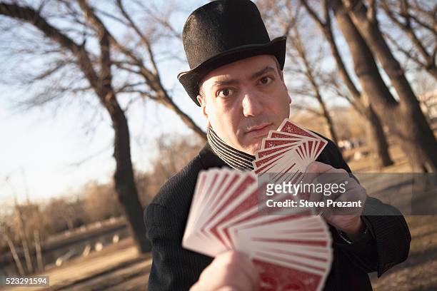 man with playing cards in a park - magician cards stock pictures, royalty-free photos & images