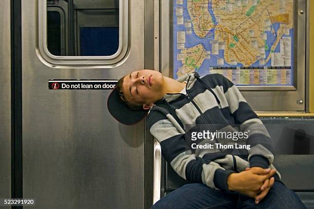 teenage boy sleeping on subway - underground train stock pictures, royalty-free photos & images