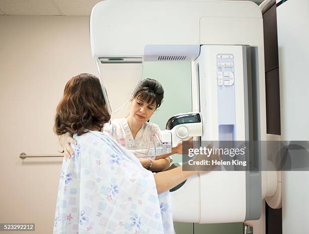 mammogram being performed - mammographie stock-fotos und bilder