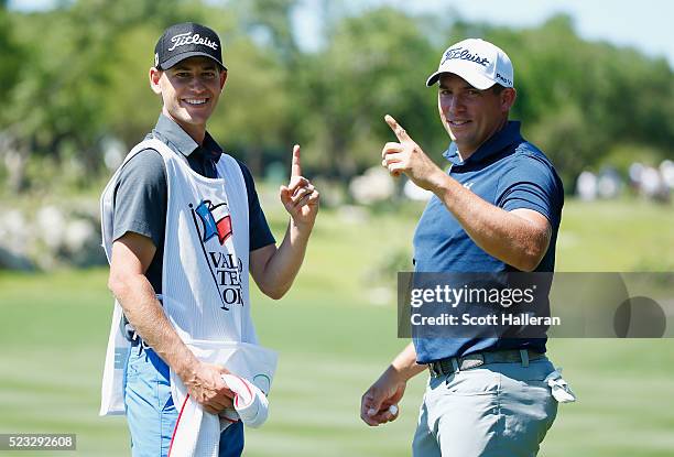 Scott Stallings and his caddie Jay Haas Jr. Pose after Stallings had a hole-in-one on the 13th hole during the second round of the Valero Texas Open...