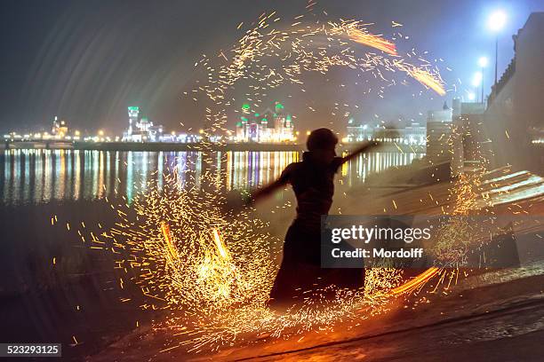 male dancer silhouette in circle of sparks - flame circle stock pictures, royalty-free photos & images