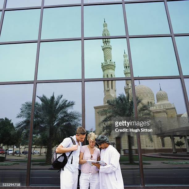 tourist couple asking for direction - couples dubai stock pictures, royalty-free photos & images