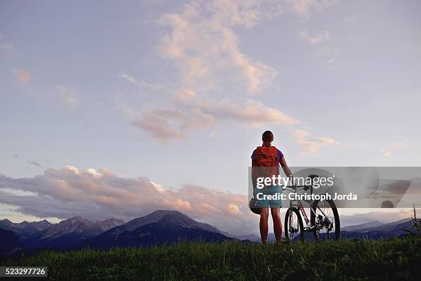 female biker looking to the nice panorama of the alps - bavaria bike stock pictures, royalty-free photos & images