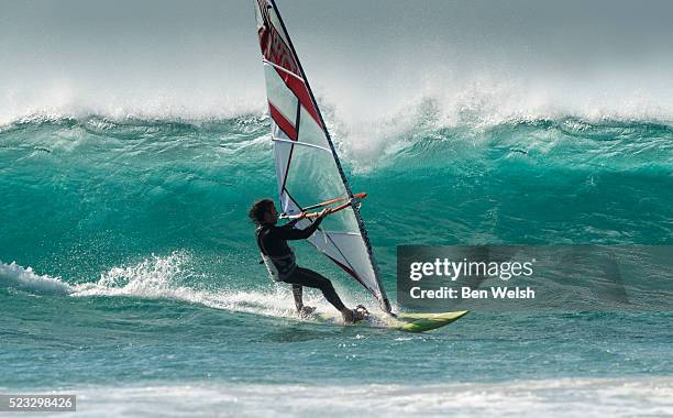 windsurfer riding a wave. - windsurfing stock pictures, royalty-free photos & images