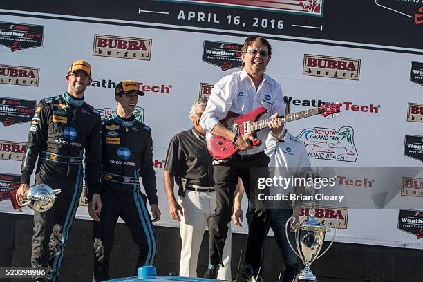 Car owner Wayne Taylor celebrates with a victory guitar after winning the IMSA WeatherTech Series race at Toyota Grand Prix of Long Beach on April...