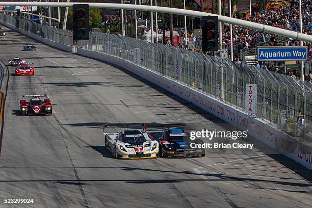 Cars race into the first turn at the start of the IMSA WeatherTech Series race at Toyota Grand Prix of Long Beach on April 16, 2016 in Long Beach,...