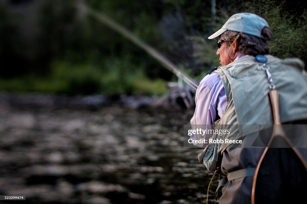 A male fly fisherman casting in a Colorado stream near Lake City, Colorado
