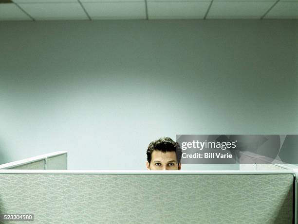 man working in cubicle - bored worker fotografías e imágenes de stock