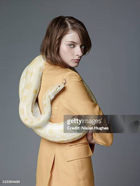 woman in suit with snake around her neck - python stock-fotos und bilder