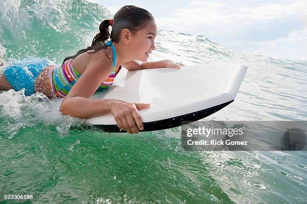 little girl bodyboarding - bodyboard fotografías e imágenes de stock