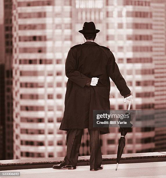 businessman in trench coat looking over city - trench coat back stock pictures, royalty-free photos & images