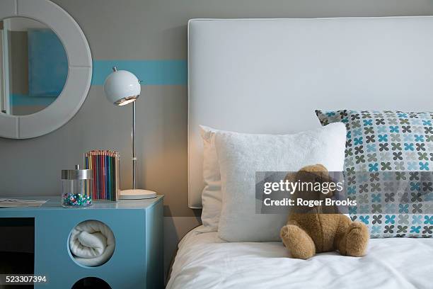 blue desk beside bed in children's room - headboard ストックフォトと画像