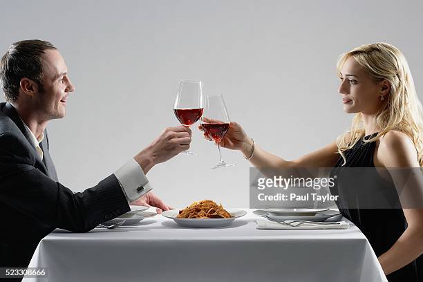 couple toasting with red wine - plate side view stock pictures, royalty-free photos & images