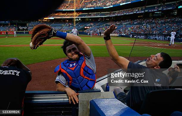 Travis d'Arnaud of the New York Mets catches a pop fly in foul territory hit by Freddie Freeman of the Atlanta Braves to end the first inning at...