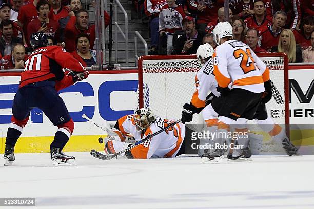 Goalie Michal Neuvirth of the Philadelphia Flyers stops a shot by Marcus Johansson of the Washington Capitals in the second period of Game Five of...