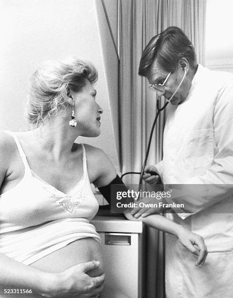 checking blood pressure of woman - 1990s woman stock pictures, royalty-free photos & images