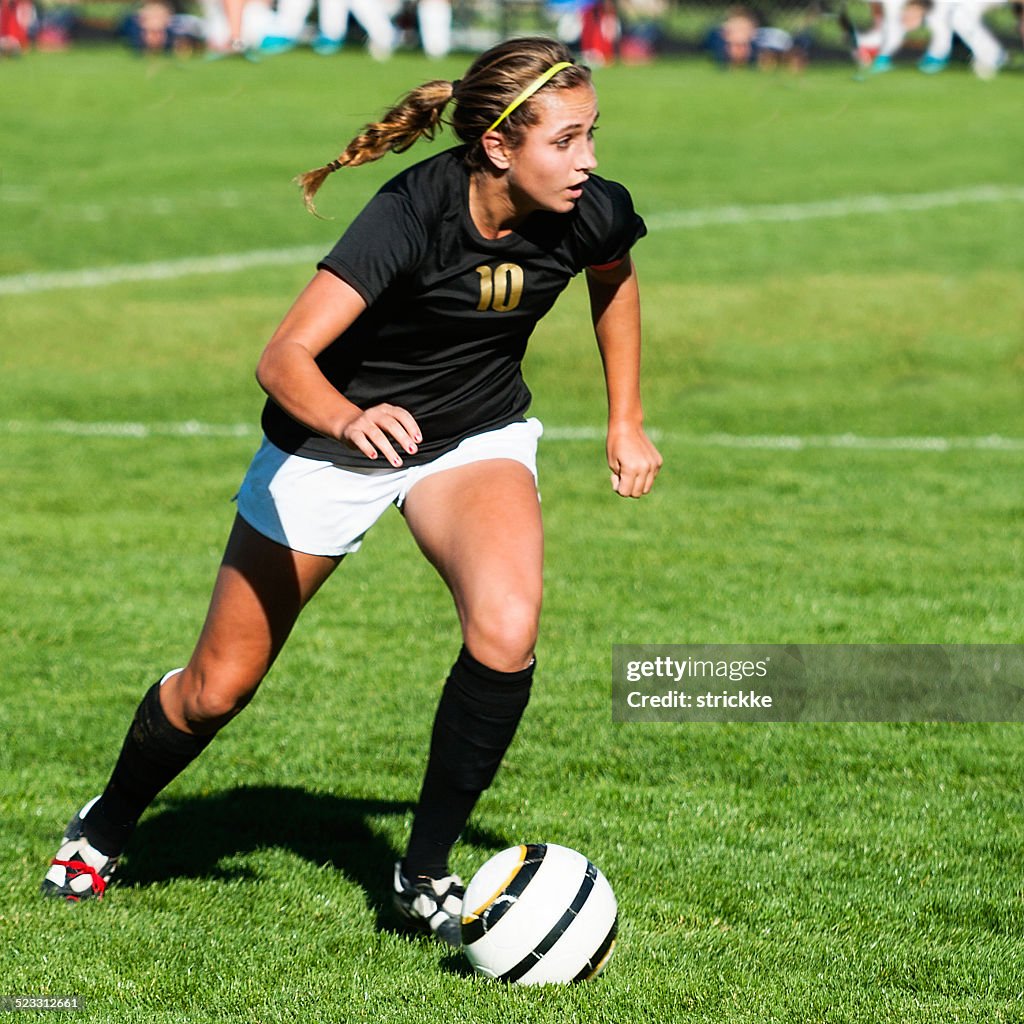 Female Soccer Player Showing Mega Intensity with Eyes Up Downfield