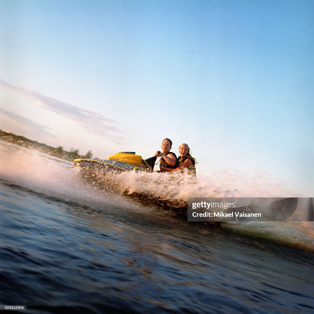 Man and Woman Riding Jet Ski