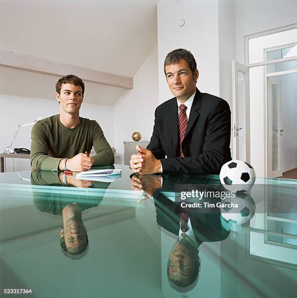 soccer player signing with sports agent - athlete signing contract stock pictures, royalty-free photos & images
