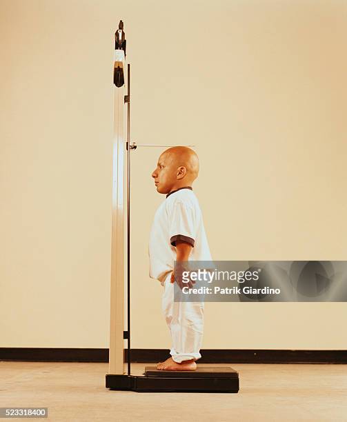 little person measuring his height - little people stock pictures, royalty-free photos & images