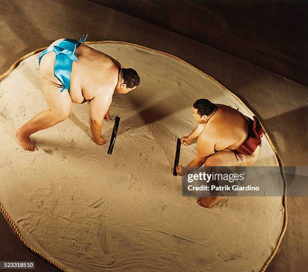 sumo wrestlers preparing to do battle - sumo wrestling stock pictures, royalty-free photos & images