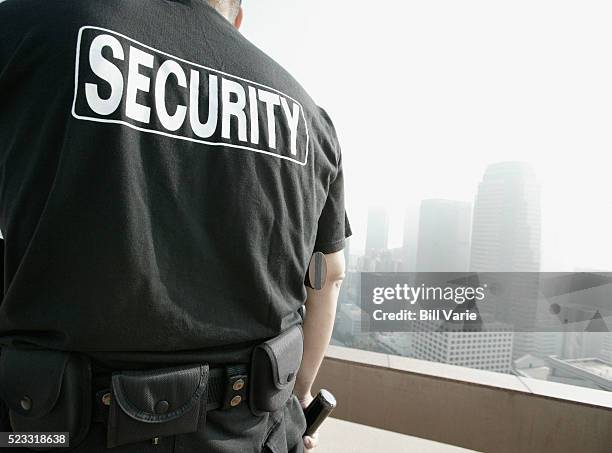 security guard on rooftop - security guard stockfoto's en -beelden