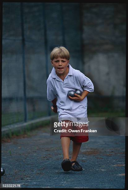 boy playing petanque - petanque court stock pictures, royalty-free photos & images