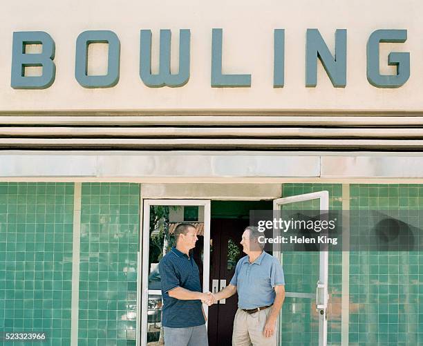 handshake at the bowling alley - bowling alley stock pictures, royalty-free photos & images