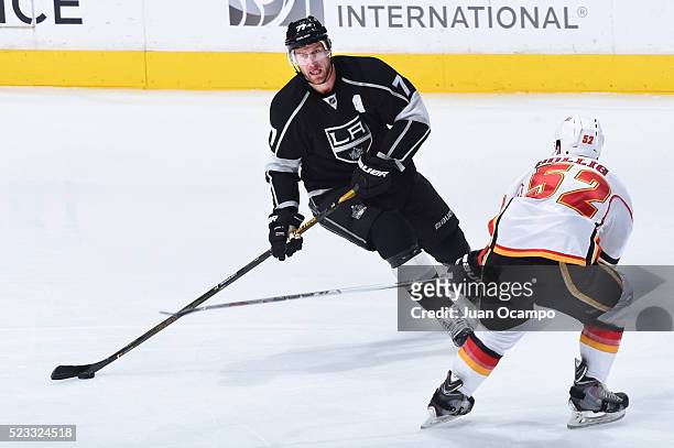 Jeff Carter of the Los Angeles Kings controls the puck against Brandon Bollig of the Calgary Flames on March 31, 2016 at Staples Center in Los...