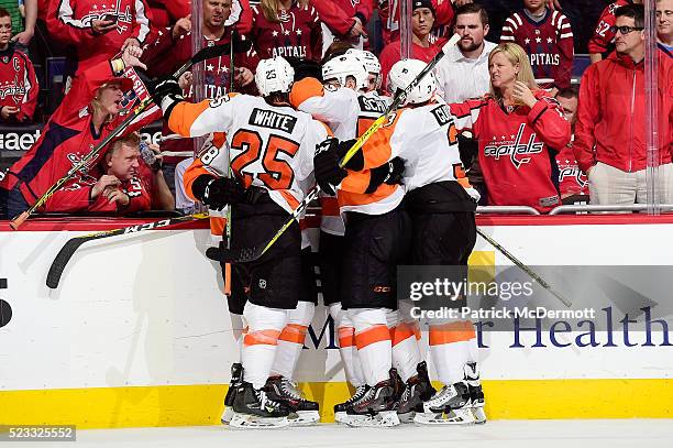 Chris VandeVelde of the Philadelphia Flyers celebrates with his teammates after scoring an empty net goal against the Washington Capitals in the...