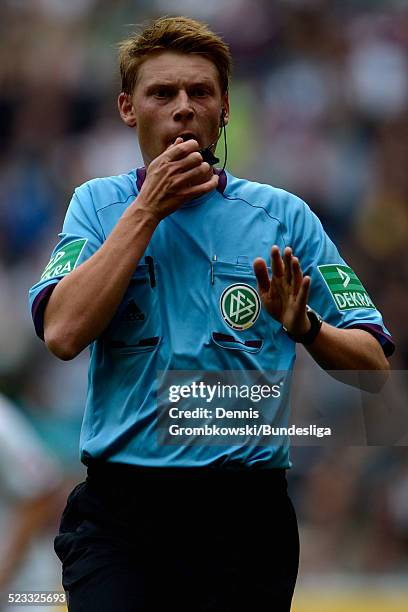 Referee Christian Dingert reacts during the Bundesliga match between VfL Borussia Moenchengladbach and 1. FC Nuernberg at Borussia Park Stadium on...