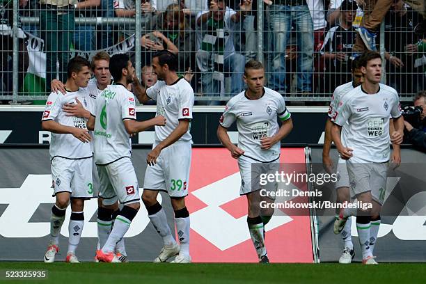 Granit Xhaka of Moenchengladbach celebrates with teammates after scoring his team's second goal during the Bundesliga match between VfL Borussia...
