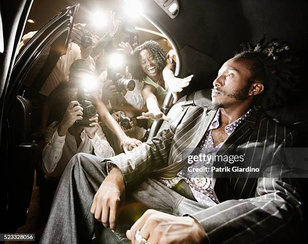celebrity in limo ignoring fans and paparazzi - red carpet limo stock pictures, royalty-free photos & images