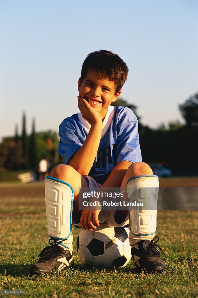 Soccer Player Sitting on Ball