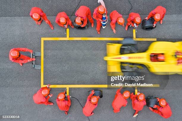 pit crew ready as racecar skids into pit box - pit stock pictures, royalty-free photos & images