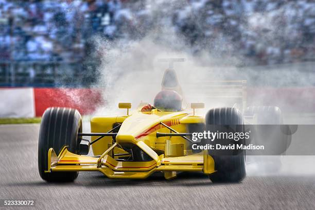 smoke pouring from open-wheel single-seater racing car racecar - autorennen stock-fotos und bilder