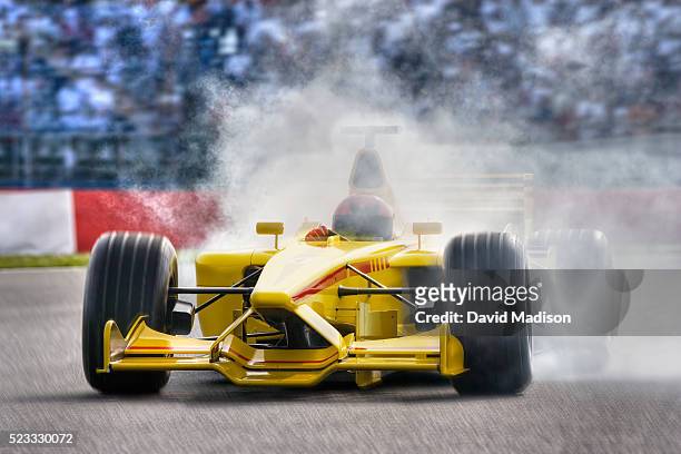 smoke pouring from open-wheel single-seater racing car racecar - car racing stadium stock pictures, royalty-free photos & images