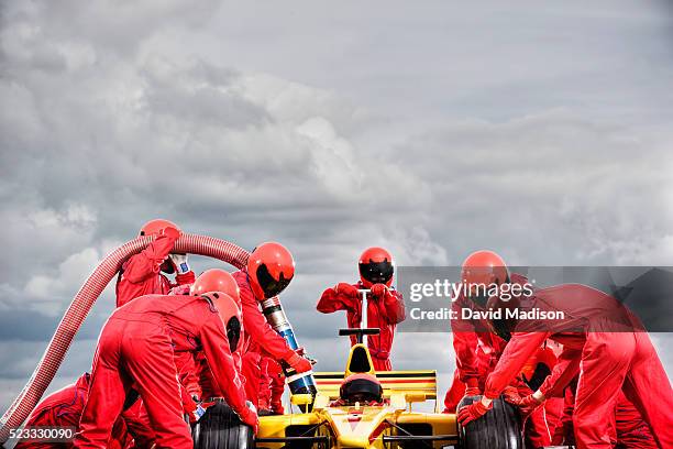 pit crew servicing open-wheel single-seater racing car racecar - pit stop stock pictures, royalty-free photos & images