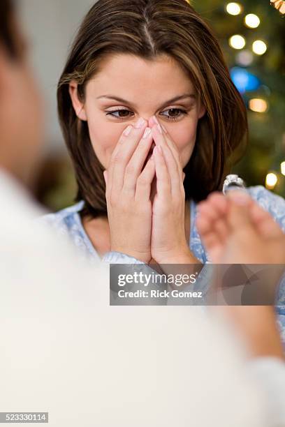 woman receiving marriage proposal - man proposing indoor stock-fotos und bilder