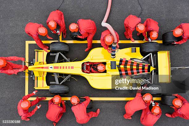 open-wheel single-seater racing car racecar in pit box during pit stop - pit stop foto e immagini stock